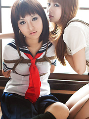 Dimdim Asian in uniform is tied in ropes by another sexy cupcake