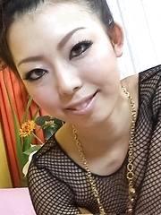 Yuki Asami Asian in fishnet strokes and rubs joystick with feet